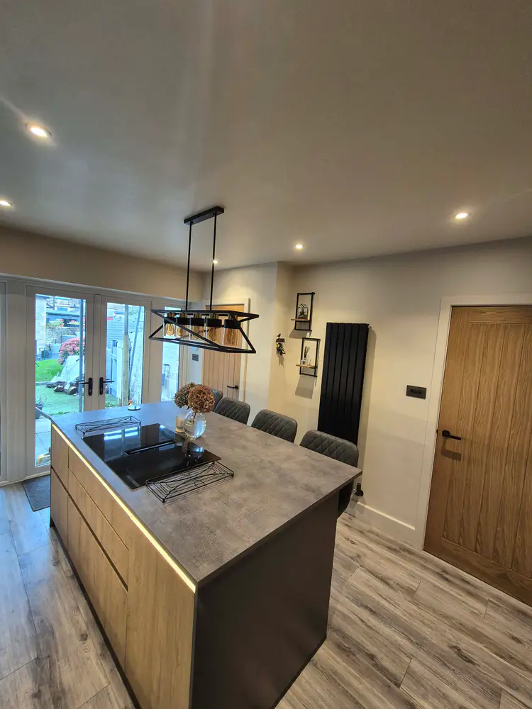 Finished kitchen with island, induction hob and dining space