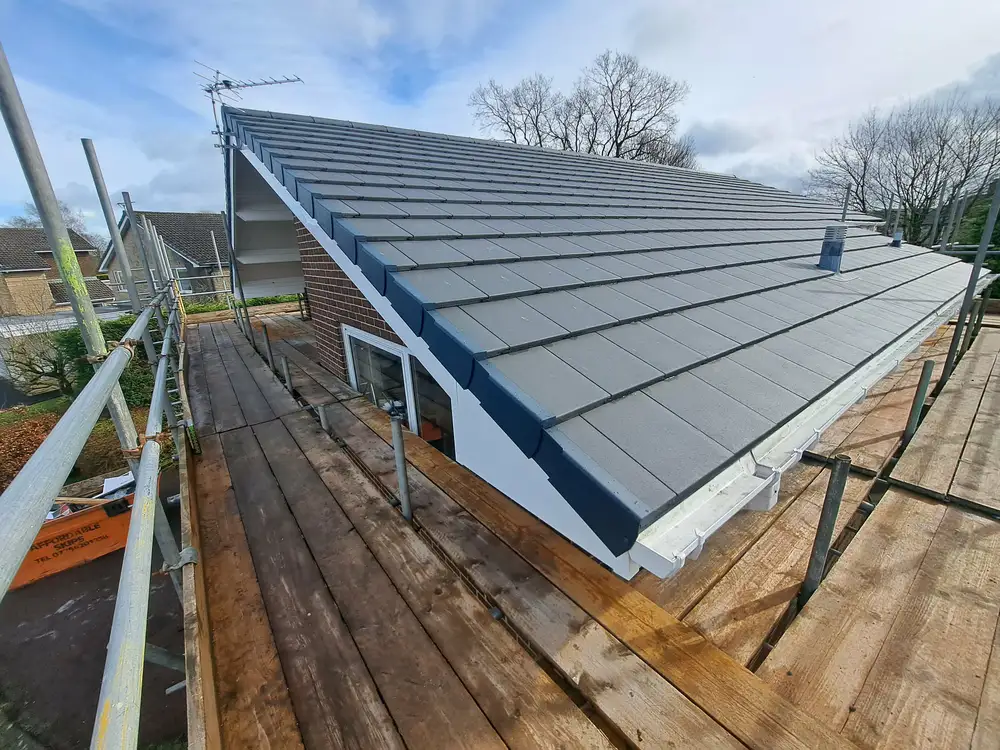 Even courses of new roof tiles and neatly finished roof edges